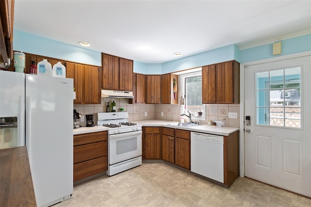 420 Fourth Rd, Wappingers Falls, NY 12590 - kitchen featuring white appliances, under cabinet range hood, a sink, brown cabinets, and light countertops