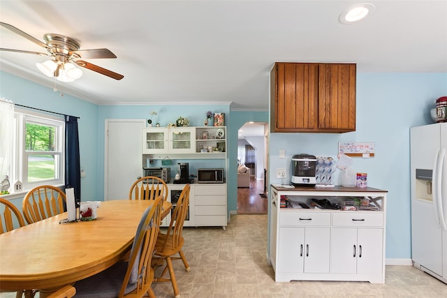 420 Fourth Rd, Wappingers Falls, NY 12590 - kitchen featuring white fridge with ice dispenser, stainless steel microwave, a ceiling fan, arched walkways, and ornamental molding