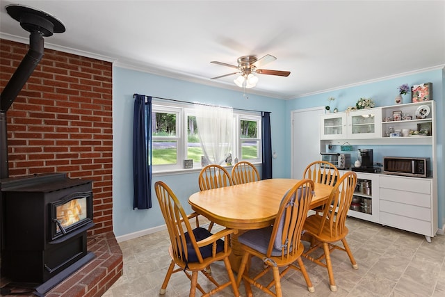 420 Fourth Rd, Wappingers Falls, NY 12590 - dining space featuring a wood stove, a ceiling fan, ornamental molding, and baseboards