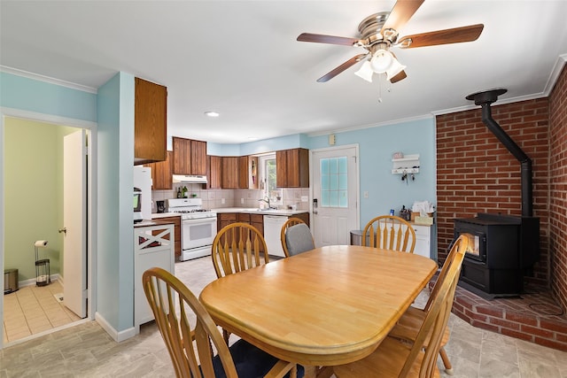 420 Fourth Rd, Wappingers Falls, NY 12590 - dining space with a wood stove, ceiling fan, crown molding, and baseboards