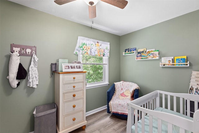 420 Fourth Rd, Wappingers Falls, NY 12590 - bedroom with wood finished floors, a nursery area, ceiling fan, and baseboards