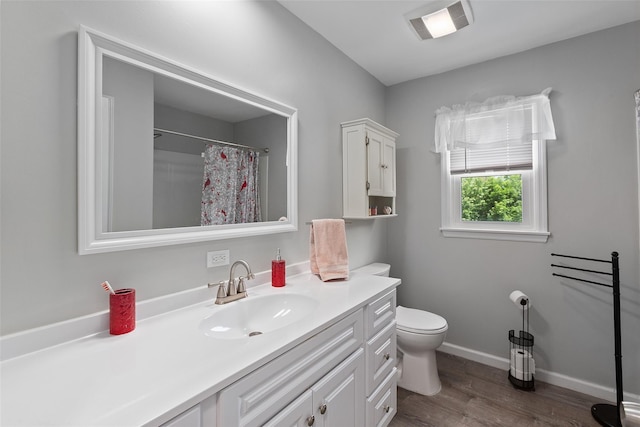 420 Fourth Rd, Wappingers Falls, NY 12590 - full bathroom with vanity, toilet, wood finished floors, baseboards, and a shower with shower curtain