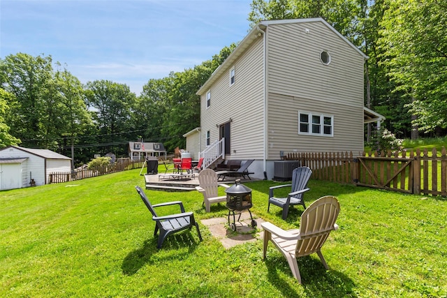 420 Fourth Rd, Wappingers Falls, NY 12590 - view of yard featuring a fire pit, central air condition unit, entry steps, view of scattered trees, and an outbuilding