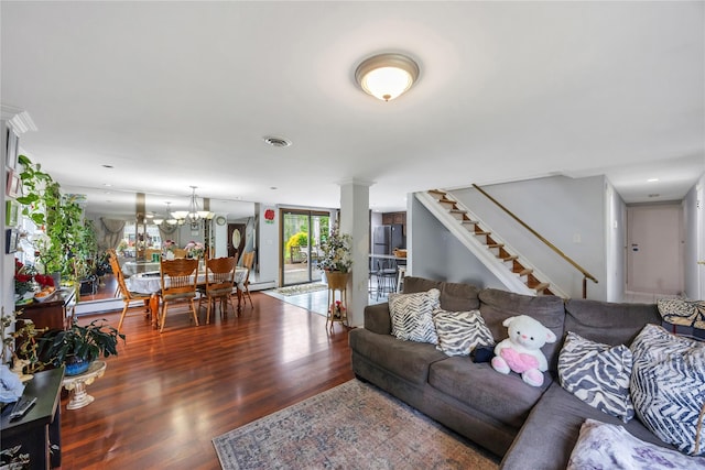 243 Sunflower Ln, Islandia, NY 11749 - living area with wood finished floors, stairs, a chandelier, and a baseboard heating unit