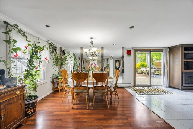243 Sunflower Ln, Islandia, NY 11749 - dining area with a chandelier, a baseboard radiator, wood finished floors, and recessed lighting