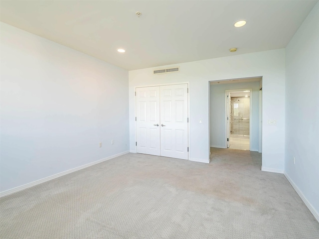 100 Harbor View Dr Unit 515, Port Washington, NY 11050 - unfurnished bedroom with light carpet, baseboards, recessed lighting, and a closet