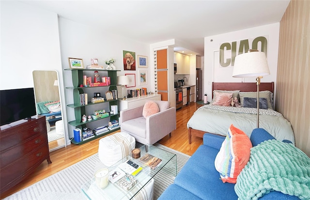 148 E 24th St Unit 5B, New York Manhattan, NY 10010 - bedroom with high end fridge, light wood-type flooring, and a sink