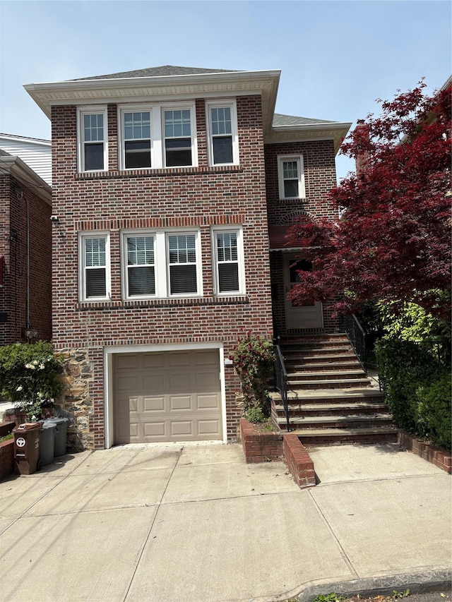 4279 Oneida Ave, Bronx, NY 10470 - view of front of house featuring an attached garage, driveway, and brick siding