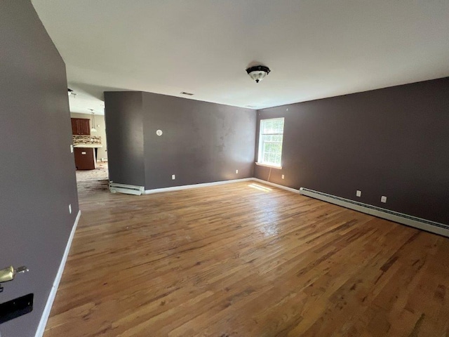 11 Willow Ln, Glen Spey, NY 12737 - empty room with baseboard heating, baseboards, and wood finished floors