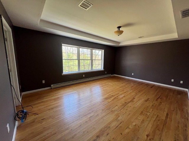 11 Willow Ln, Glen Spey, NY 12737 - spare room with a tray ceiling, a baseboard radiator, wood finished floors, and baseboards