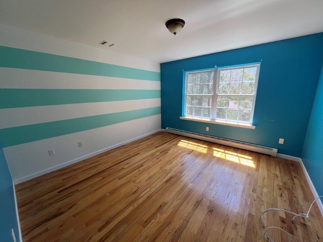 11 Willow Ln, Glen Spey, NY 12737 - unfurnished room with a baseboard heating unit, wood finished floors, and baseboards