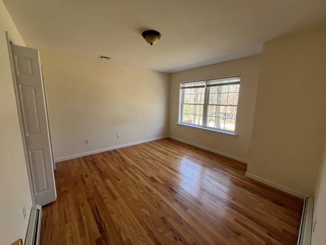 11 Willow Ln, Glen Spey, NY 12737 - unfurnished room with a baseboard heating unit, wood finished floors, and baseboards