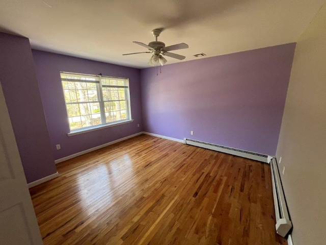 11 Willow Ln, Glen Spey, NY 12737 - empty room featuring wood finished floors, a baseboard heating unit, ceiling fan, and baseboards