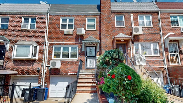 30-33 79th St, East Elmhurst, NY 11370 - multi unit property featuring brick siding, driveway, and a garage