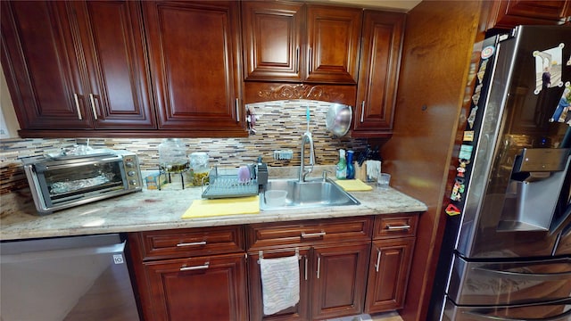 30-33 79th St, East Elmhurst, NY 11370 - kitchen featuring appliances with stainless steel finishes, a sink, decorative backsplash, and light stone counters