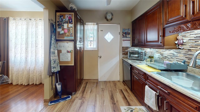 30-33 79th St, East Elmhurst, NY 11370 - kitchen featuring dishwasher, a sink, light wood-type flooring, and light countertops