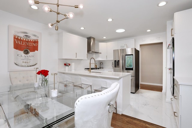 100 Dowd St Unit C12, Haverstraw, NY 10927 - kitchen featuring wall chimney exhaust hood, stainless steel appliances, white cabinets, light countertops, and recessed lighting