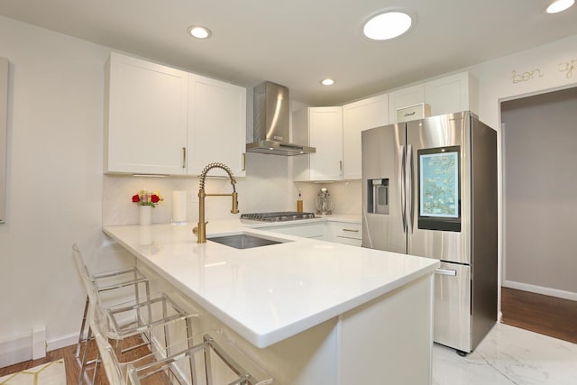 100 Dowd St Unit C12, Haverstraw, NY 10927 - kitchen with stainless steel appliances, wall chimney range hood, a sink, light countertops, and recessed lighting