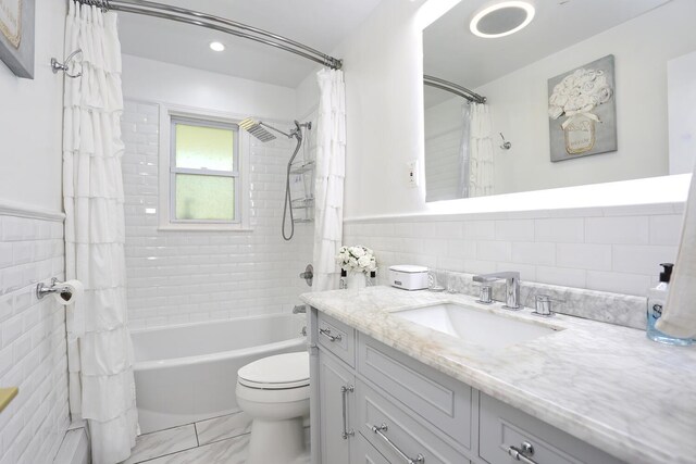 100 Dowd St Unit C12, Haverstraw, NY 10927 - full bathroom with tile walls, shower / bath combo, toilet, vanity, and a wainscoted wall