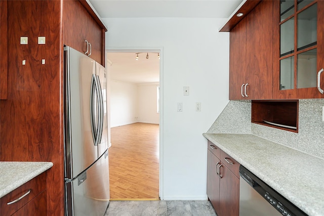 7445 Yellowstone Blvd Unit 5C, Rego Park, NY 11374 - kitchen with appliances with stainless steel finishes, light countertops, backsplash, glass insert cabinets, and baseboards