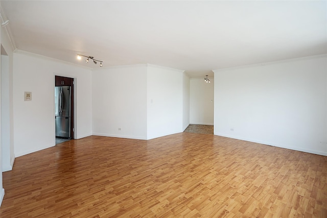 7445 Yellowstone Blvd Unit 5C, Rego Park, NY 11374 - empty room with light wood-style flooring, crown molding, track lighting, and baseboards