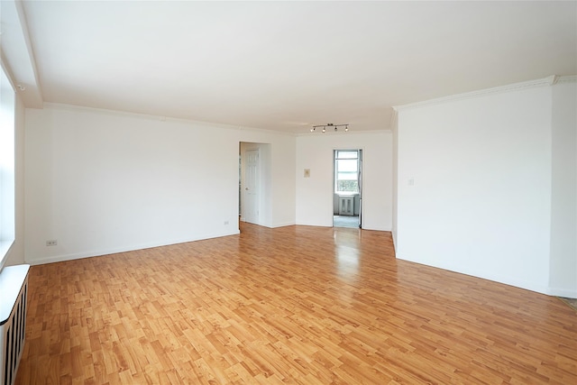 7445 Yellowstone Blvd Unit 5C, Rego Park, NY 11374 - unfurnished room with light wood-style flooring, track lighting, and crown molding