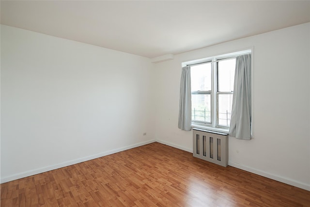 7445 Yellowstone Blvd Unit 5C, Rego Park, NY 11374 - spare room featuring light wood-type flooring and baseboards