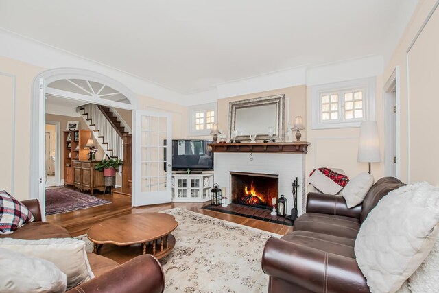 37 Lee Ave, Yonkers, NY 10705 - living room featuring wood finished floors, a brick fireplace, and stairs