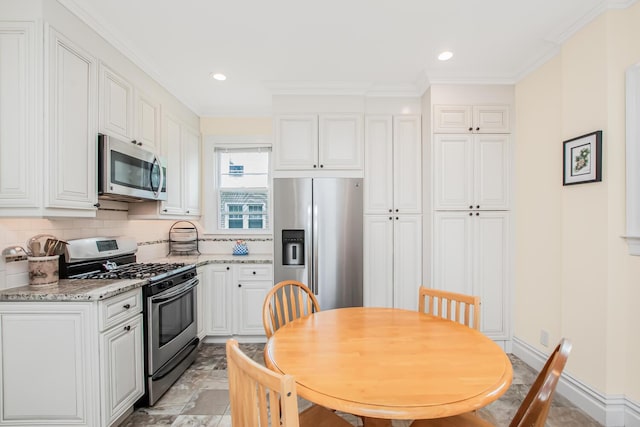 37 Lee Ave, Yonkers, NY 10705 - kitchen featuring stainless steel appliances, white cabinets, tasteful backsplash, ornamental molding, and light stone countertops