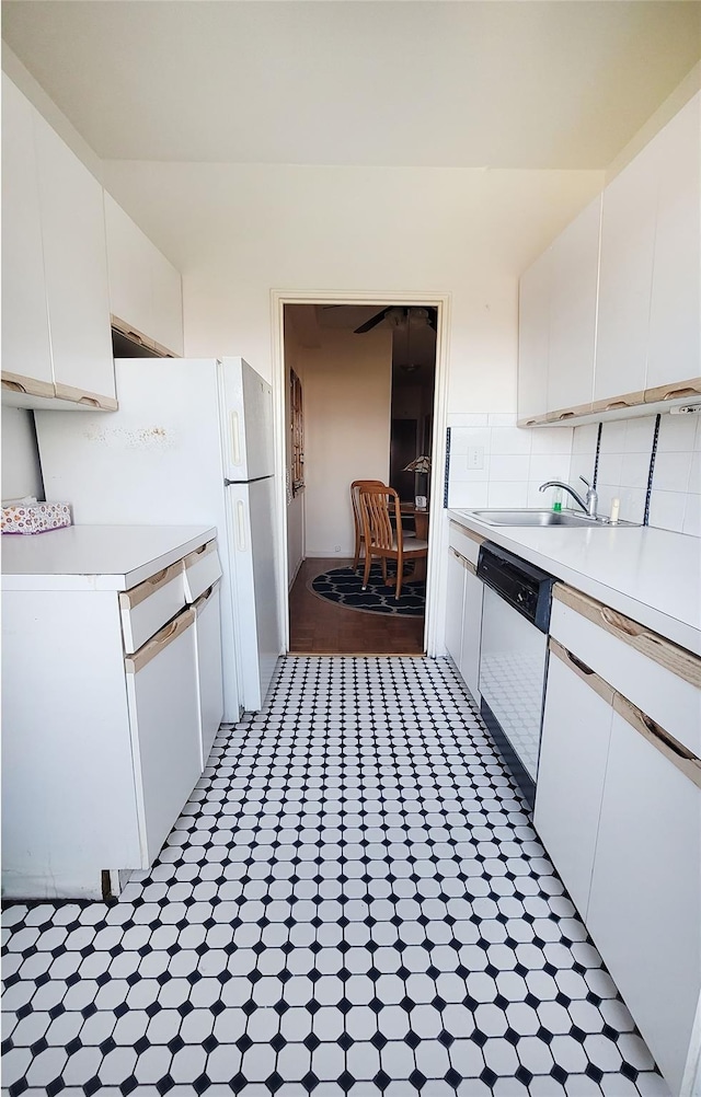 99-72 66rd Unit 7Aa, Rego Park, NY 11374 - kitchen with dishwashing machine, a sink, white cabinets, light countertops, and tasteful backsplash