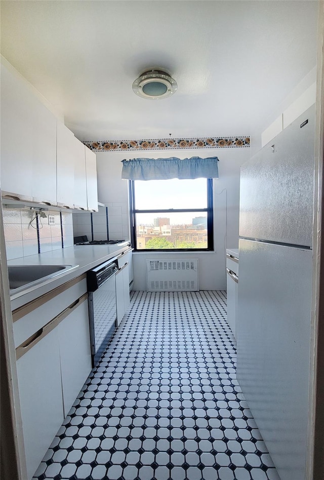 99-72 66rd Unit 7Aa, Rego Park, NY 11374 - kitchen with freestanding refrigerator, radiator, dishwasher, white cabinetry, and light countertops