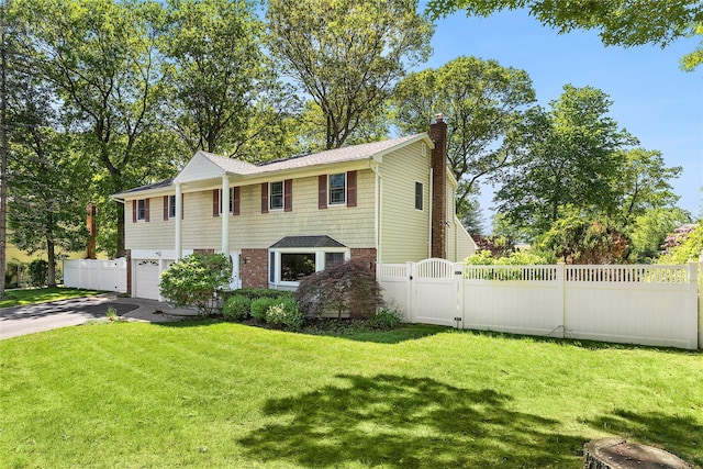 4 Lt John Olsen Ln, Saint James, NY 11780 - view of front facade featuring concrete driveway, a chimney, an attached garage, and a gate