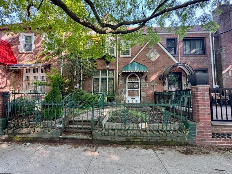 172-18 111th Ave, Jamaica, NY 11433 - view of front of property with a fenced front yard and brick siding