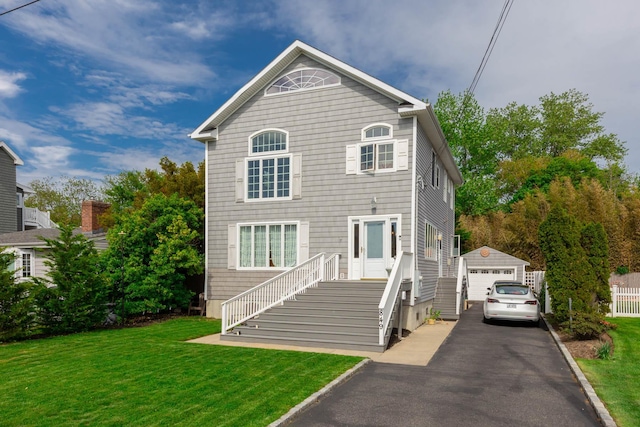 849 E Bay Dr, West Islip, NY 11795 - rear view of property with driveway, an outbuilding, a garage, and a lawn