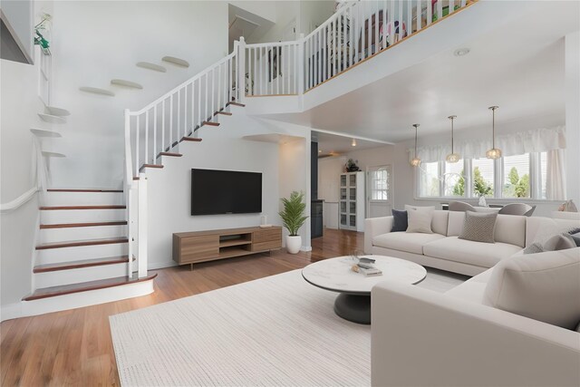849 E Bay Dr, West Islip, NY 11795 - living area with stairs, healthy amount of natural light, wood finished floors, and a high ceiling