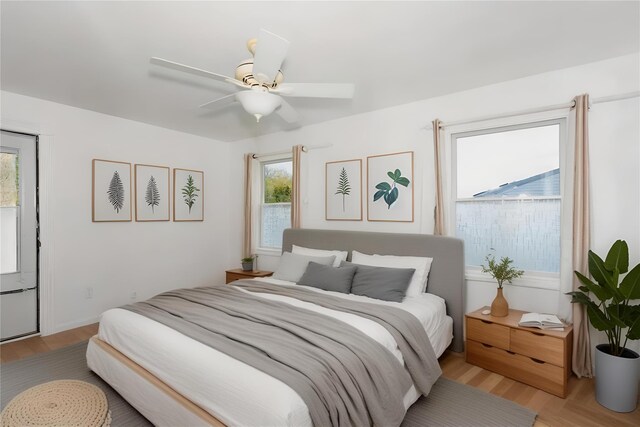 849 E Bay Dr, West Islip, NY 11795 - bedroom with multiple windows, light wood finished floors, and a ceiling fan