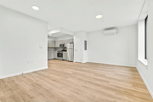 1727 Lacombe Ave Unit 2B, Bronx, NY 10473 - unfurnished living room featuring an AC wall unit, light wood-style flooring, electric panel, and recessed lighting
