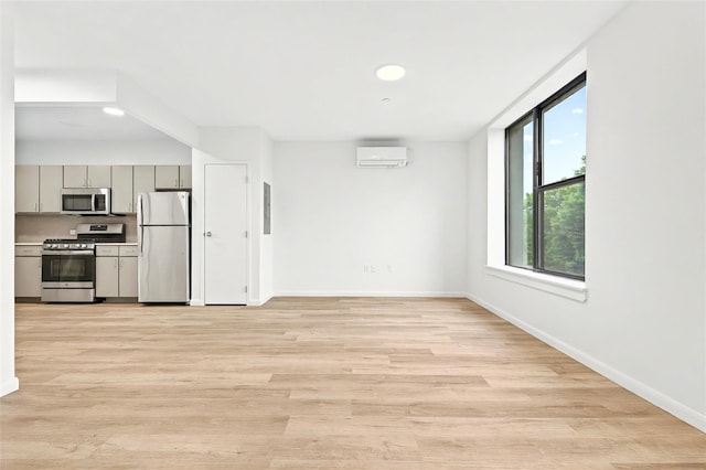 1727 Lacombe Ave Unit 2B, Bronx, NY 10473 - unfurnished living room featuring a wall unit AC, light wood finished floors, and recessed lighting