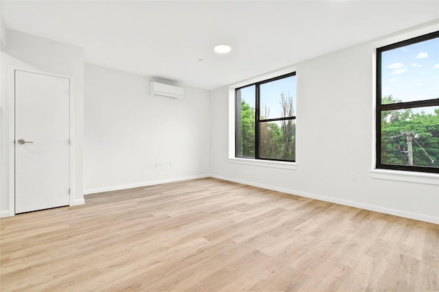 1727 Lacombe Ave Unit 2B, Bronx, NY 10473 - spare room featuring a wall mounted air conditioner, plenty of natural light, and light wood-style flooring