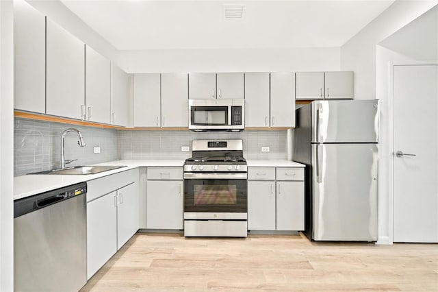 1727 Lacombe Ave Unit 2B, Bronx, NY 10473 - kitchen featuring appliances with stainless steel finishes, gray cabinetry, light countertops, and light wood-style flooring