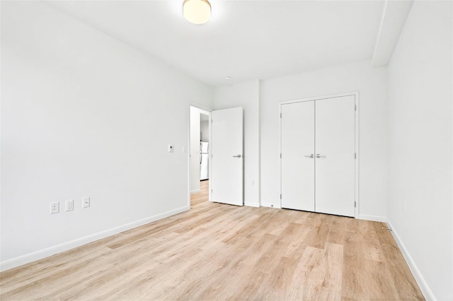 1727 Lacombe Ave Unit 2B, Bronx, NY 10473 - unfurnished bedroom featuring light wood-style floors, freestanding refrigerator, and a closet