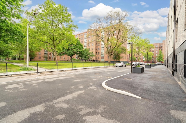 1727 Lacombe Ave Unit 2B, Bronx, NY 10473 - view of asphalt road featuring street lights, curbs, and sidewalks