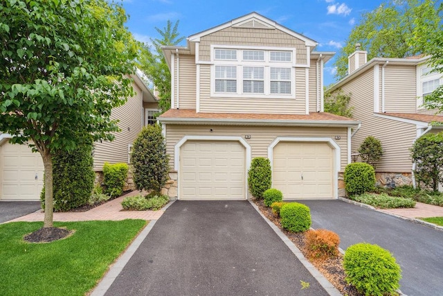 76 Sagamore Dr, Plainview, NY 11803 - view of front facade with asphalt driveway, a garage, and stone siding