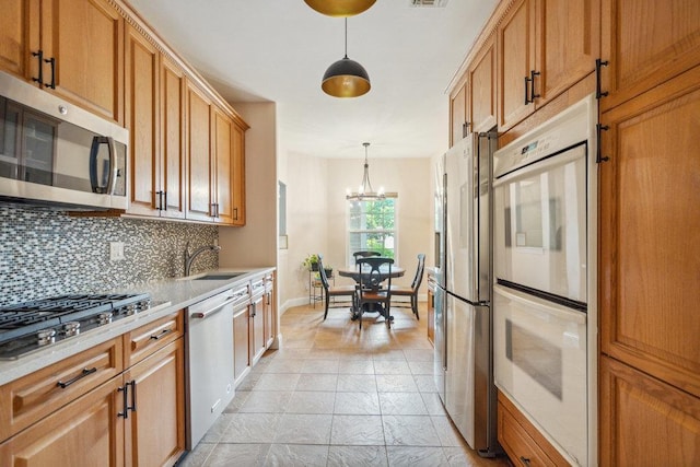 76 Sagamore Dr, Plainview, NY 11803 - kitchen with appliances with stainless steel finishes, a sink, tasteful backsplash, light countertops, and a chandelier