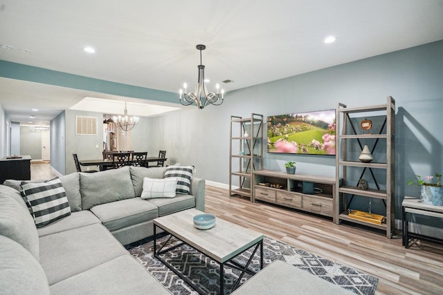 76 Sagamore Dr, Plainview, NY 11803 - living room featuring a chandelier, wood finished floors, recessed lighting, and baseboards