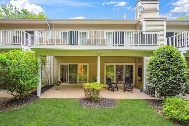 76 Sagamore Dr, Plainview, NY 11803 - back of property with a balcony, a patio, and a lawn