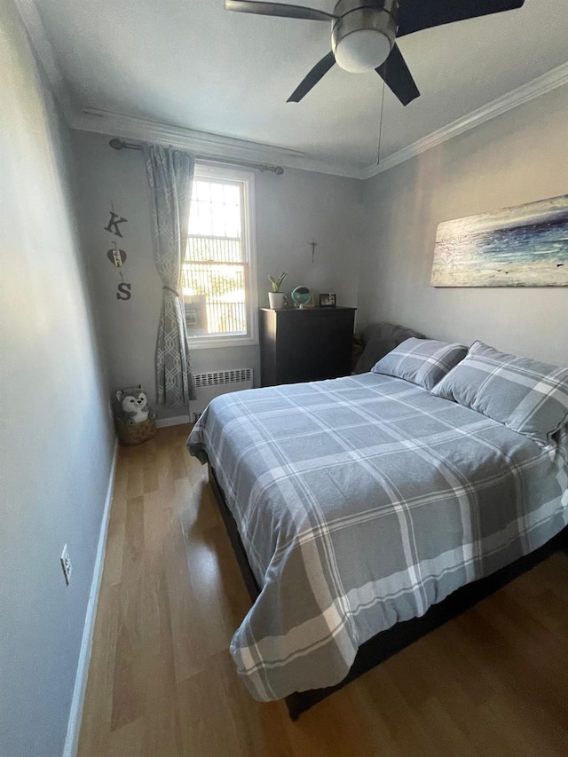 108-41 51st Ave, Corona, NY 11368 - bedroom featuring radiator, wood finished floors, ornamental molding, baseboards, and a ceiling fan