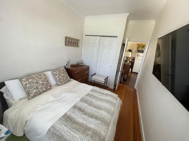 108-41 51st Ave, Corona, NY 11368 - bedroom featuring freestanding refrigerator, crown molding, wood finished floors, and a closet