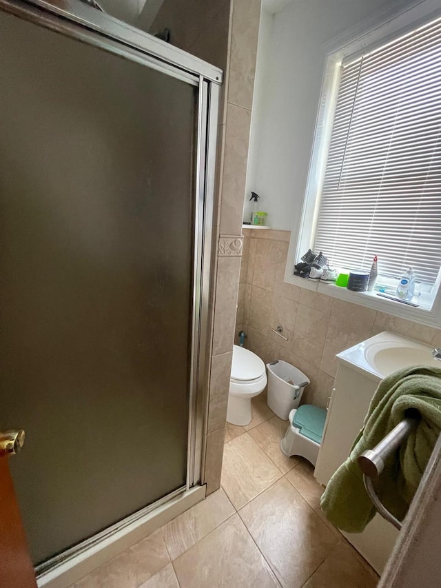 108-41 51st Ave, Corona, NY 11368 - full bath with toilet, a shower stall, tile walls, tile patterned flooring, and a wainscoted wall