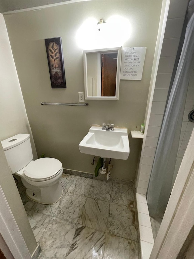 108-41 51st Ave, Corona, NY 11368 - bathroom featuring a sink, toilet, marble finish floors, a stall shower, and baseboards